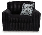 Black chair and a half with geometric throw pillow on the seat