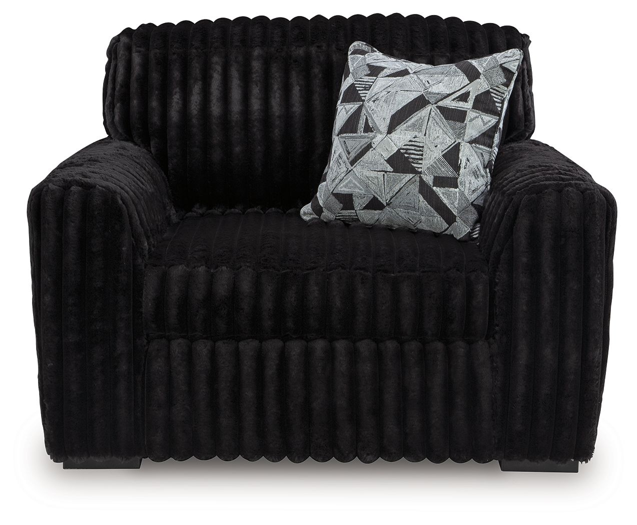 Black chair and a half with geometric throw pillow on the seat