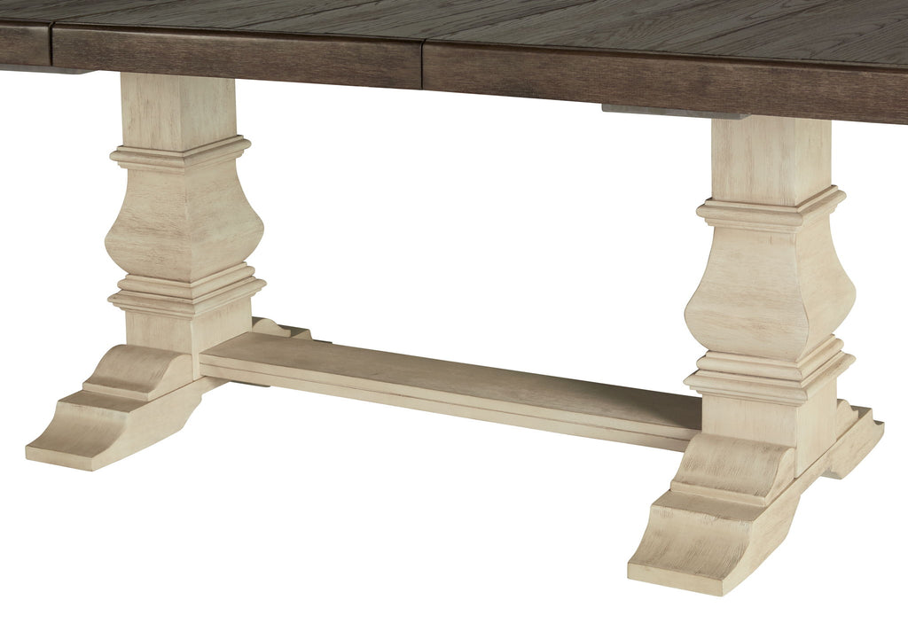 Dining table with brown tabletop and beige turned pedestal legs