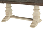 Dining table with brown tabletop and beige turned pedestal legs