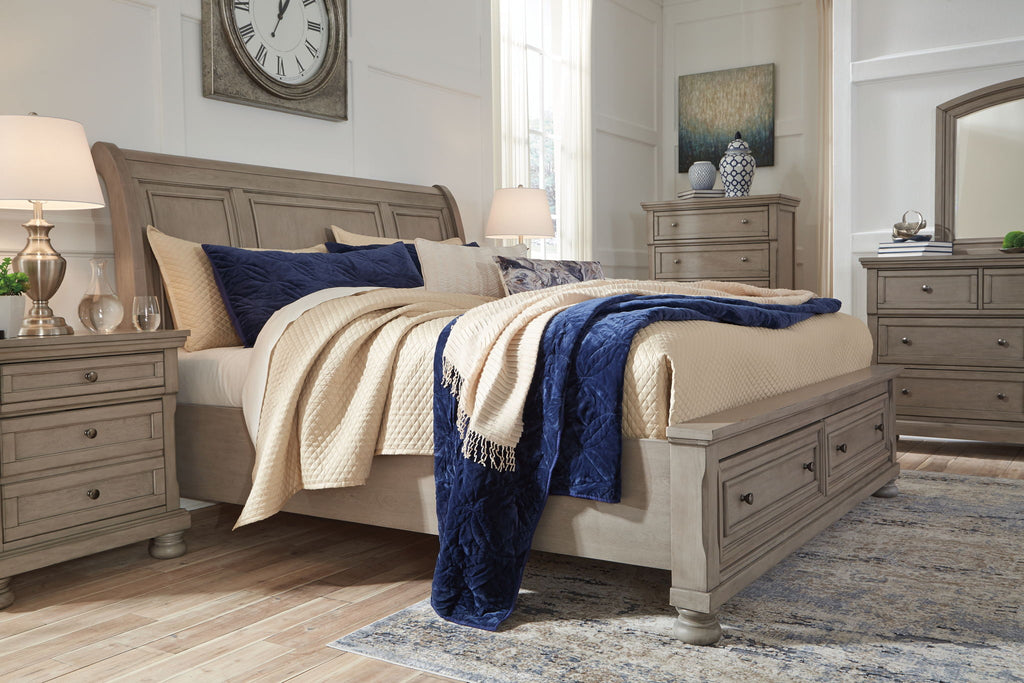 Lettner sleigh bed with drawers, gray frame and quilted blue accent pillow