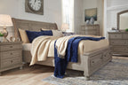 Lettner sleigh bed with drawers, gray frame and quilted blue accent pillow