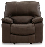 Dark brown rocker recliner chair with padded back and armrests, rolled cushions