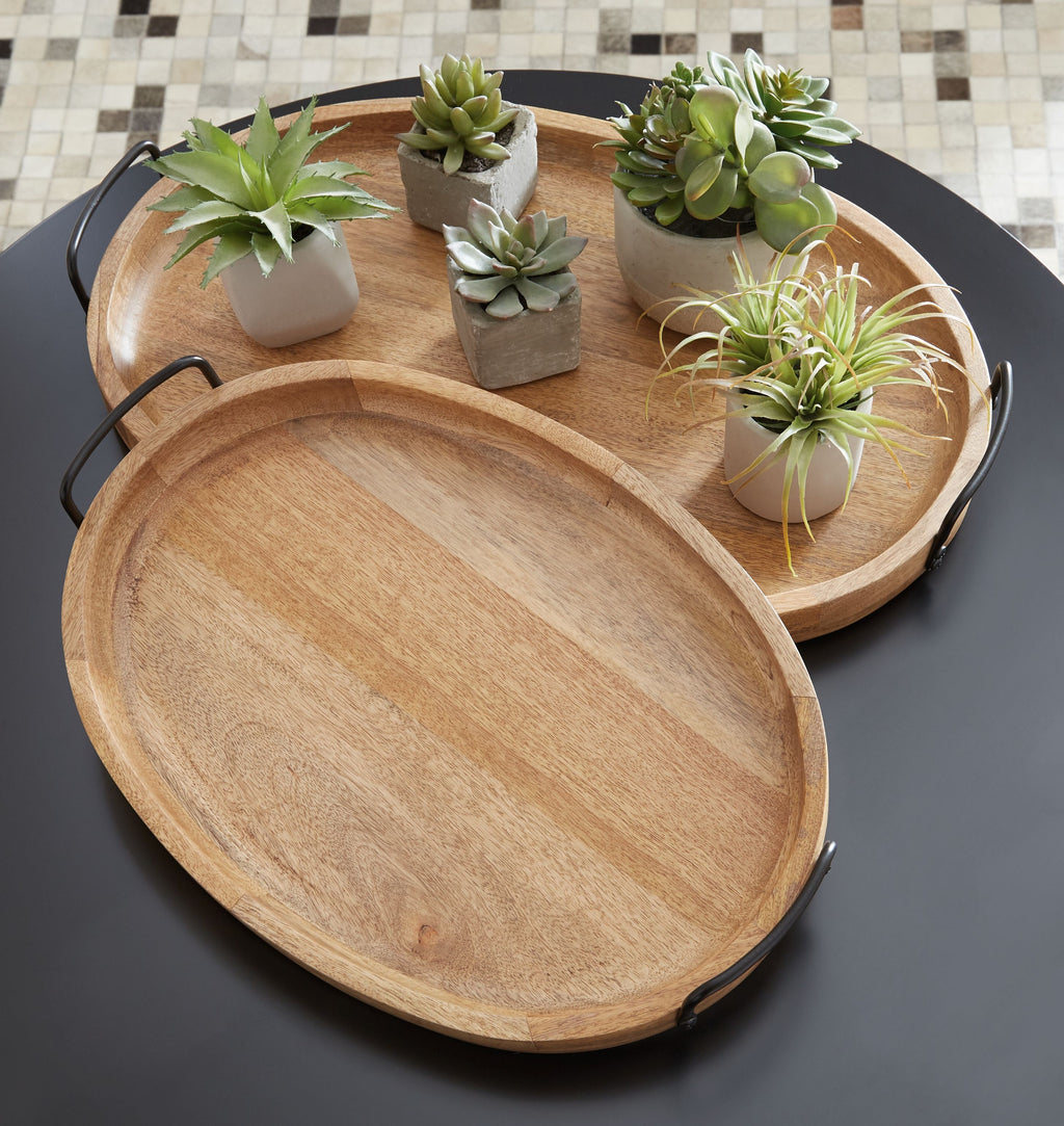 Two wooden serving trays with black handles, one stacked, styled with small plants.
