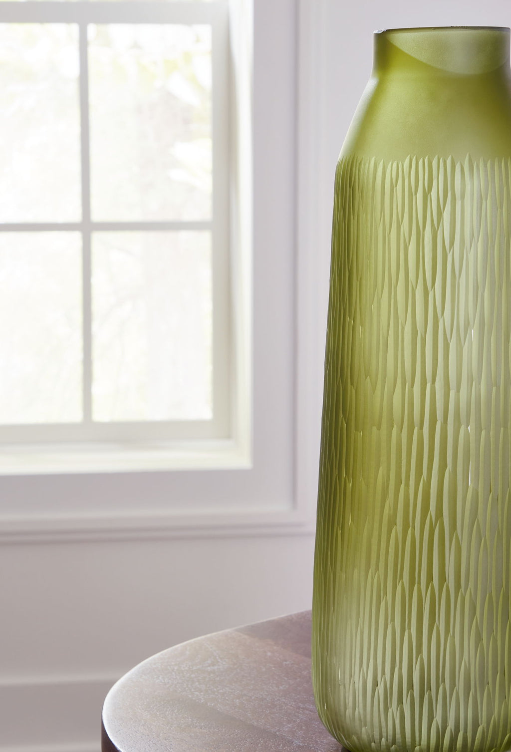 Olive green glass vase with vertical ridges, narrow neck and open top