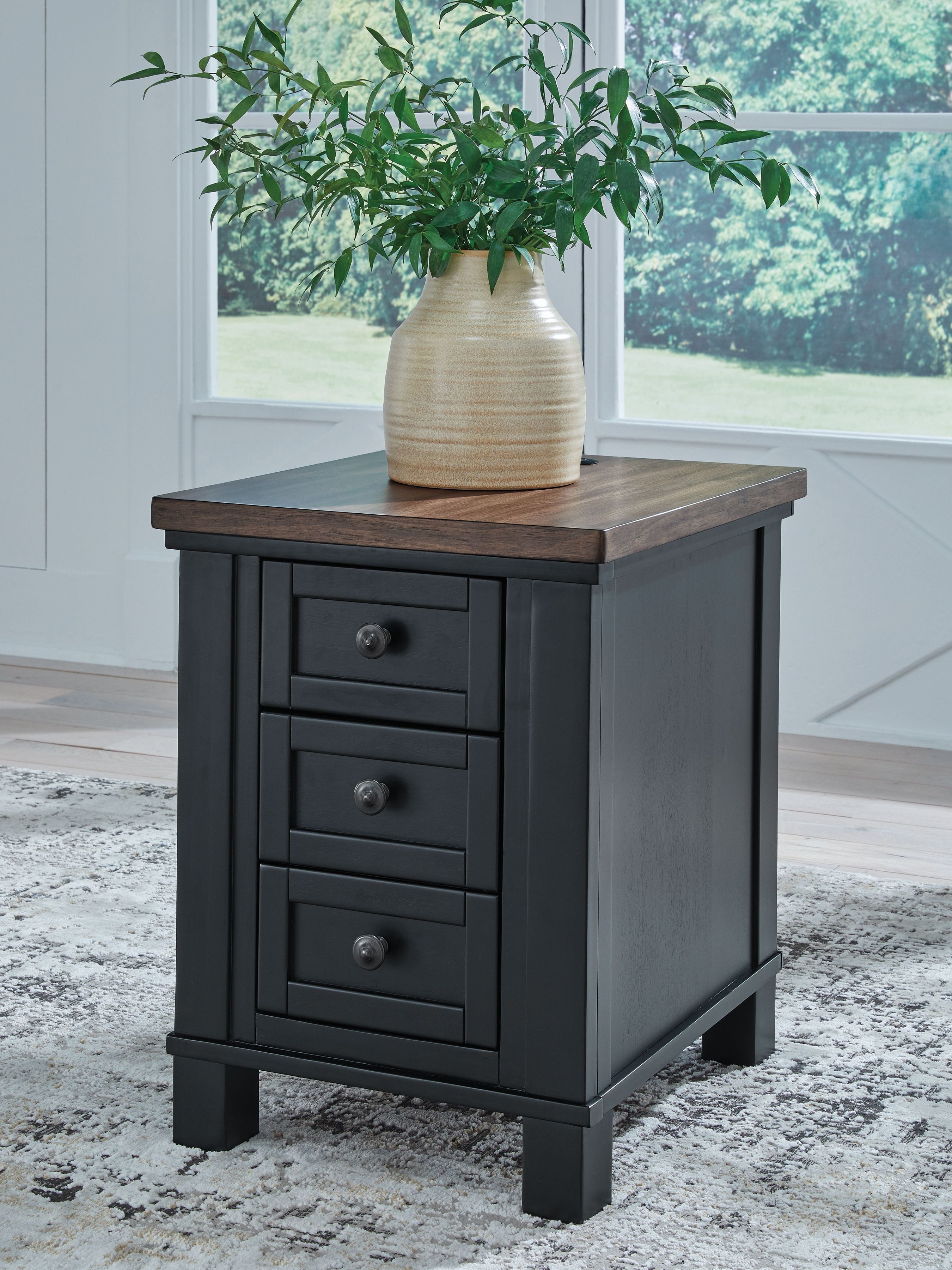Black chair side end table with brown top, three drawers, and round metal knobs