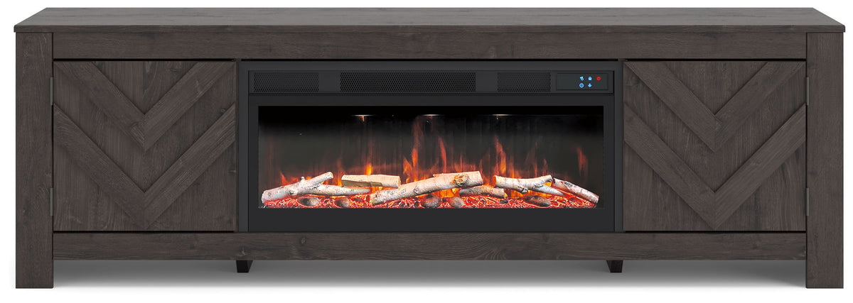 Dark TV stand with glowing fireplace insert behind glass, chevron side panels