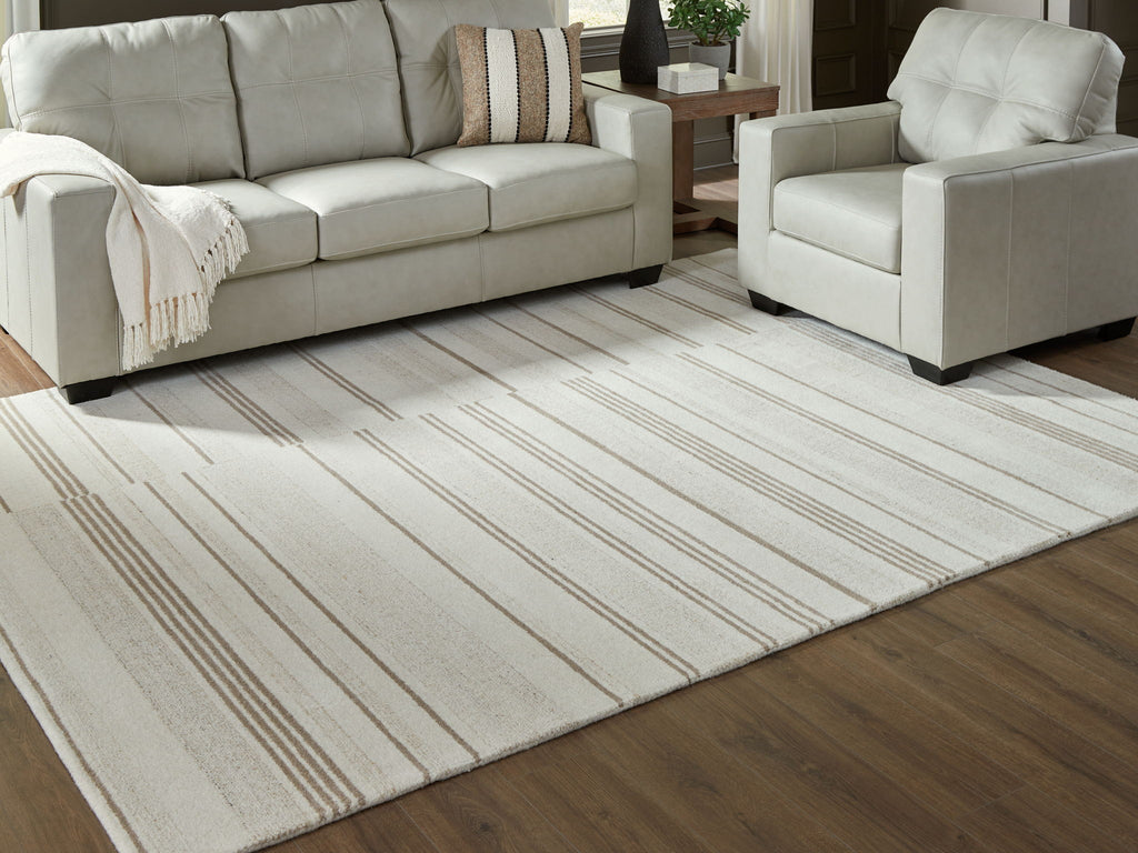 Rectangular off-white area rug with beige horizontal stripes under seating