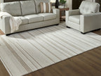 Rectangular off-white area rug with beige horizontal stripes under seating