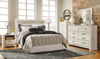 Beige panel headboard with bolt-on metal bed frame and patterned bedding