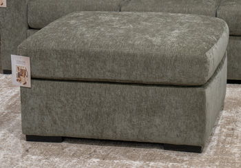 Dark green upholstered oversized accent ottoman with squared arms and short legs