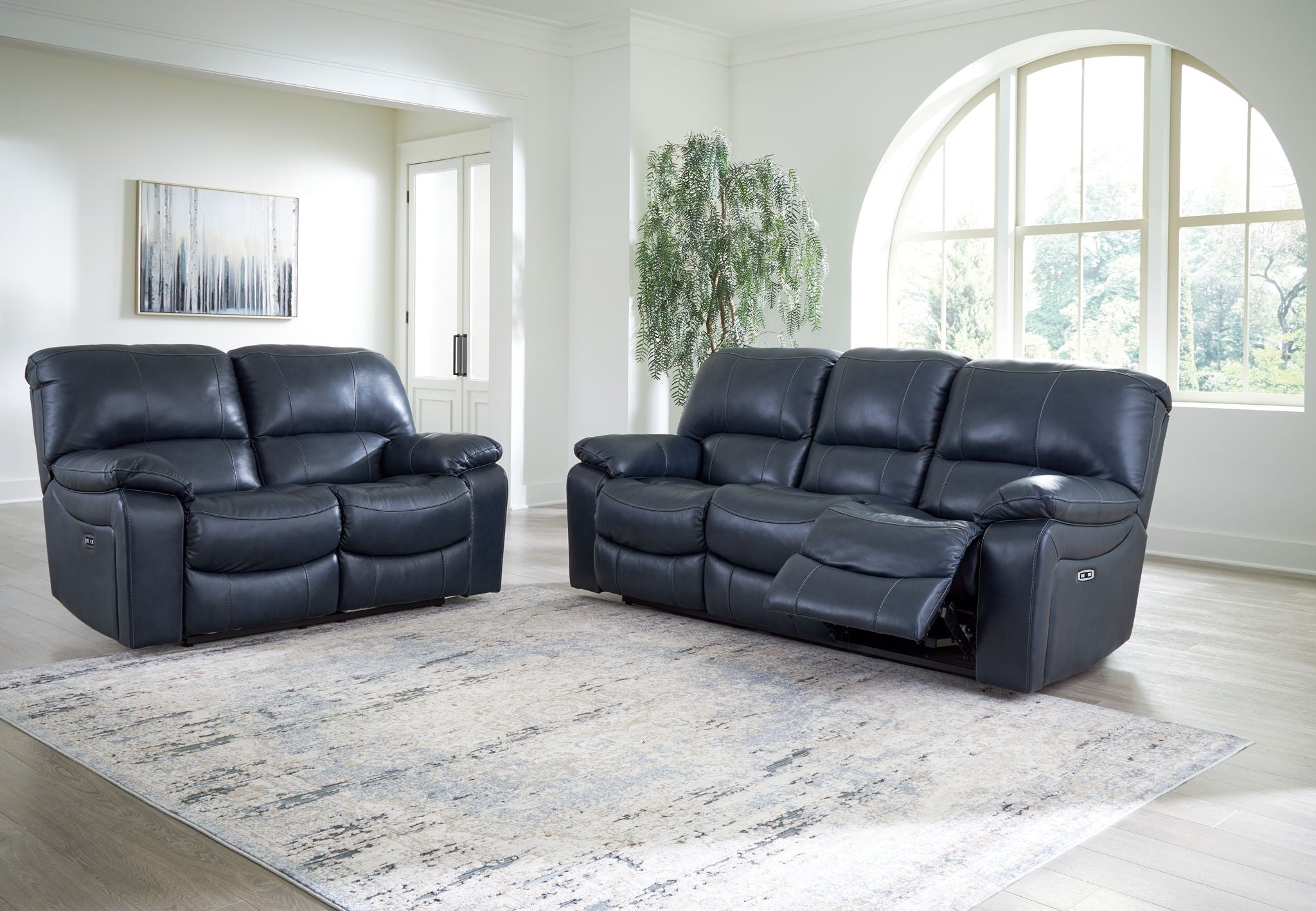 Navy blue reclining living room set with sofa and matching loveseat-style recliner