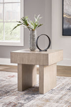 Square end table in light grayish brown with vase and mirror on top.
