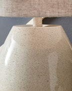 Speckled beige lamp base with small neck and linen drum shade top