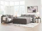 Sofa sleeper with bed extended, gray upholstery and matching throw pillows.