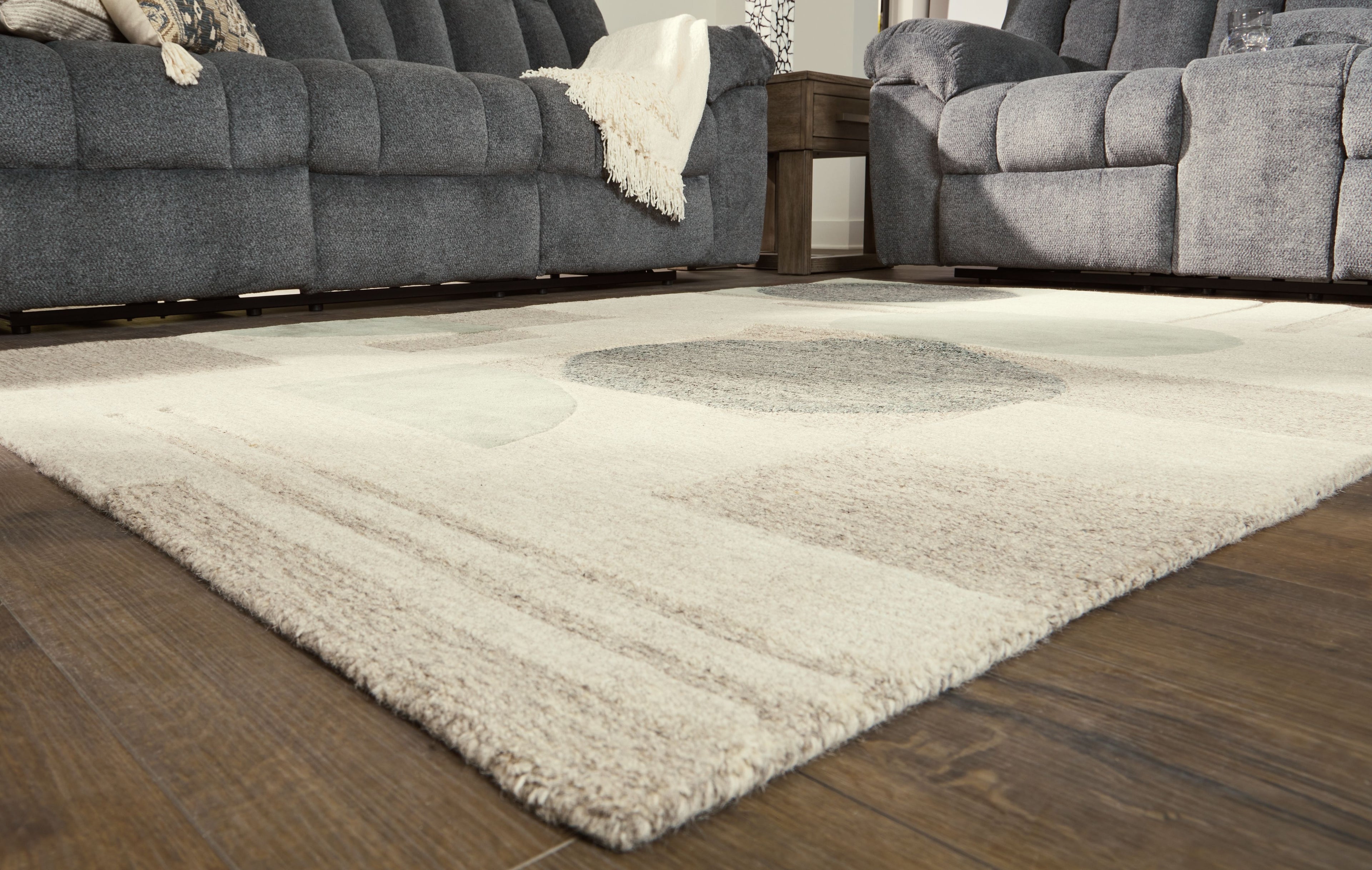 Ivory rug with abstract shapes in gray and sage, plush low-shedding pile