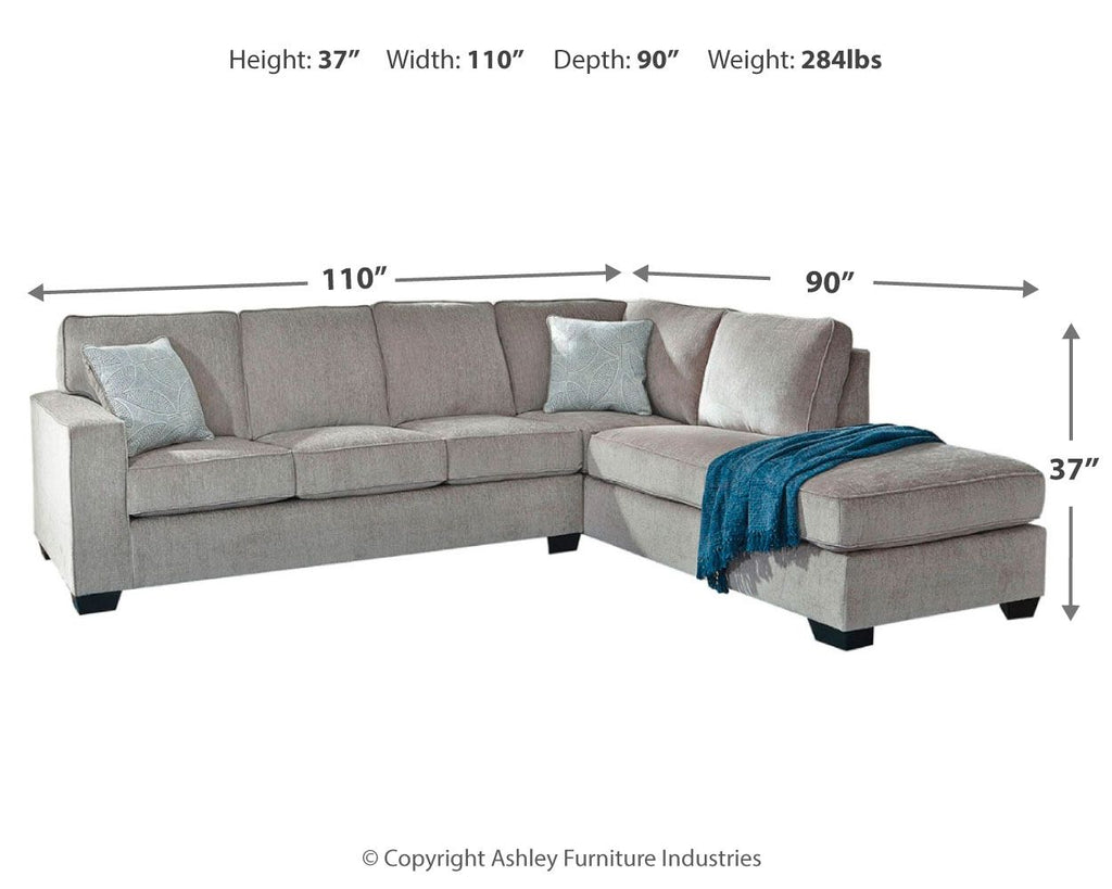 Light gray sectional sleeper sofa with right chaise and throw blanket on the ottoman