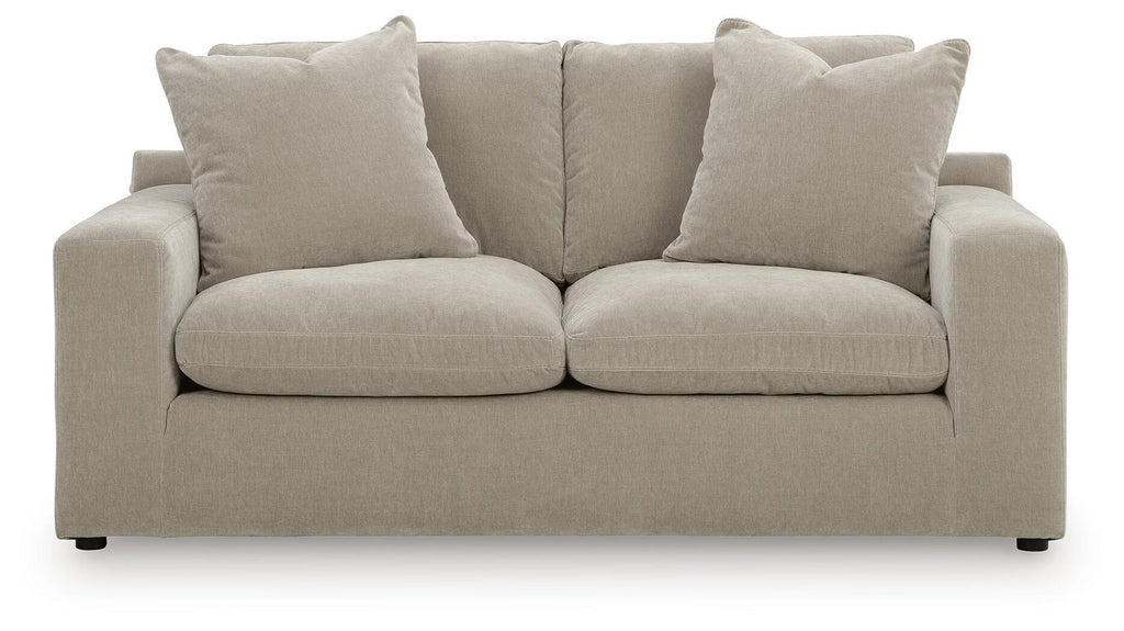 Gray loveseat with two seat cushions and four back pillows, slim dark feet