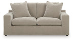 Gray loveseat with two seat cushions and four back pillows, slim dark feet