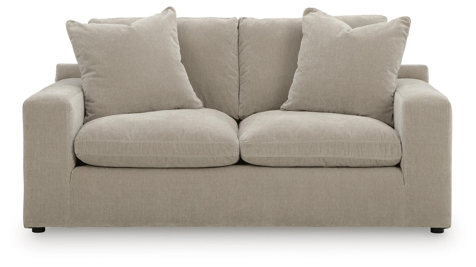 Gray loveseat with two seat cushions and four back pillows, slim dark feet