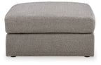 Smoke gray ottoman with rounded cushioned seat and low profile
