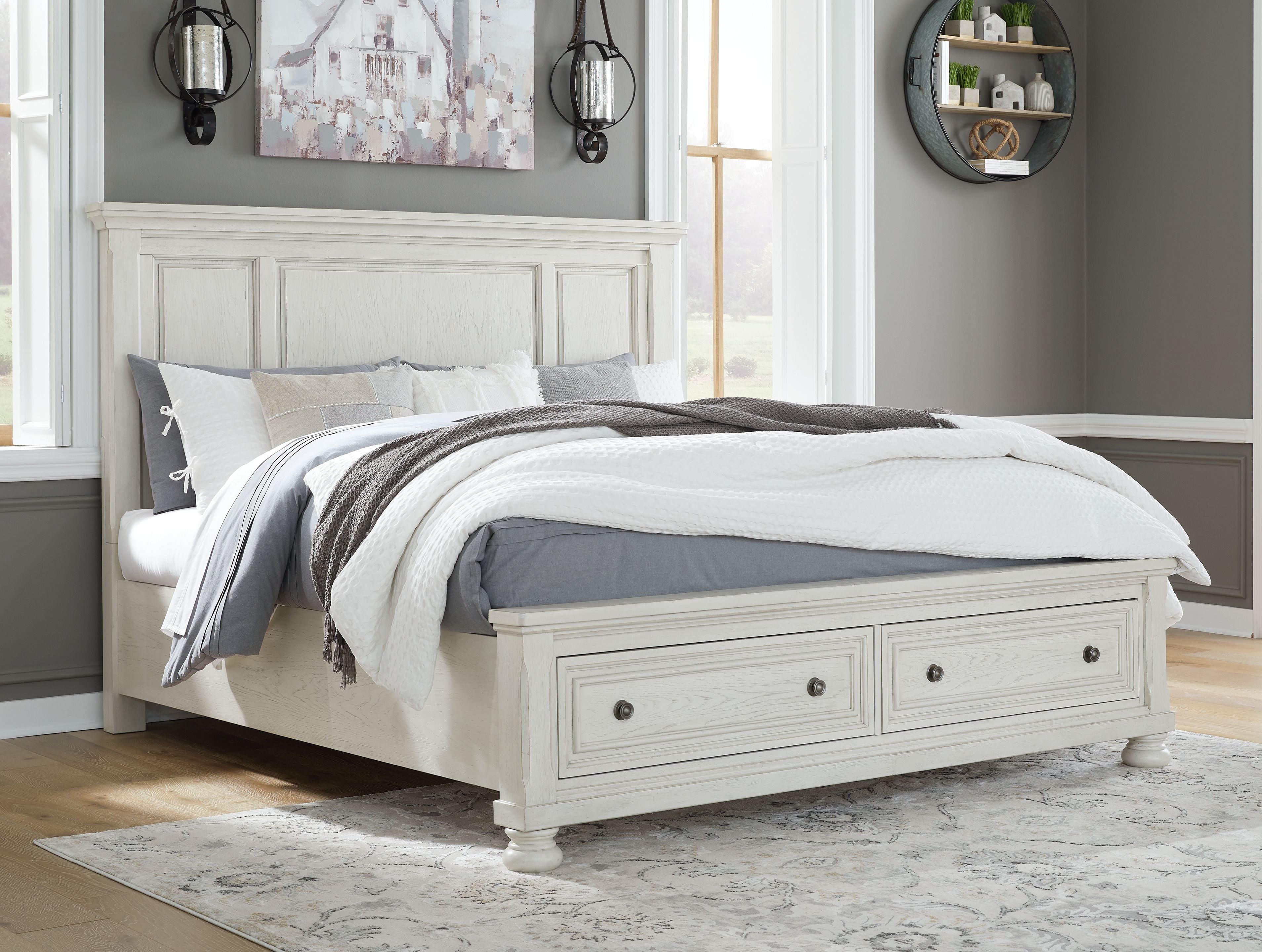 White panel storage bed with two drawers, panel headboard, pillows on mattress