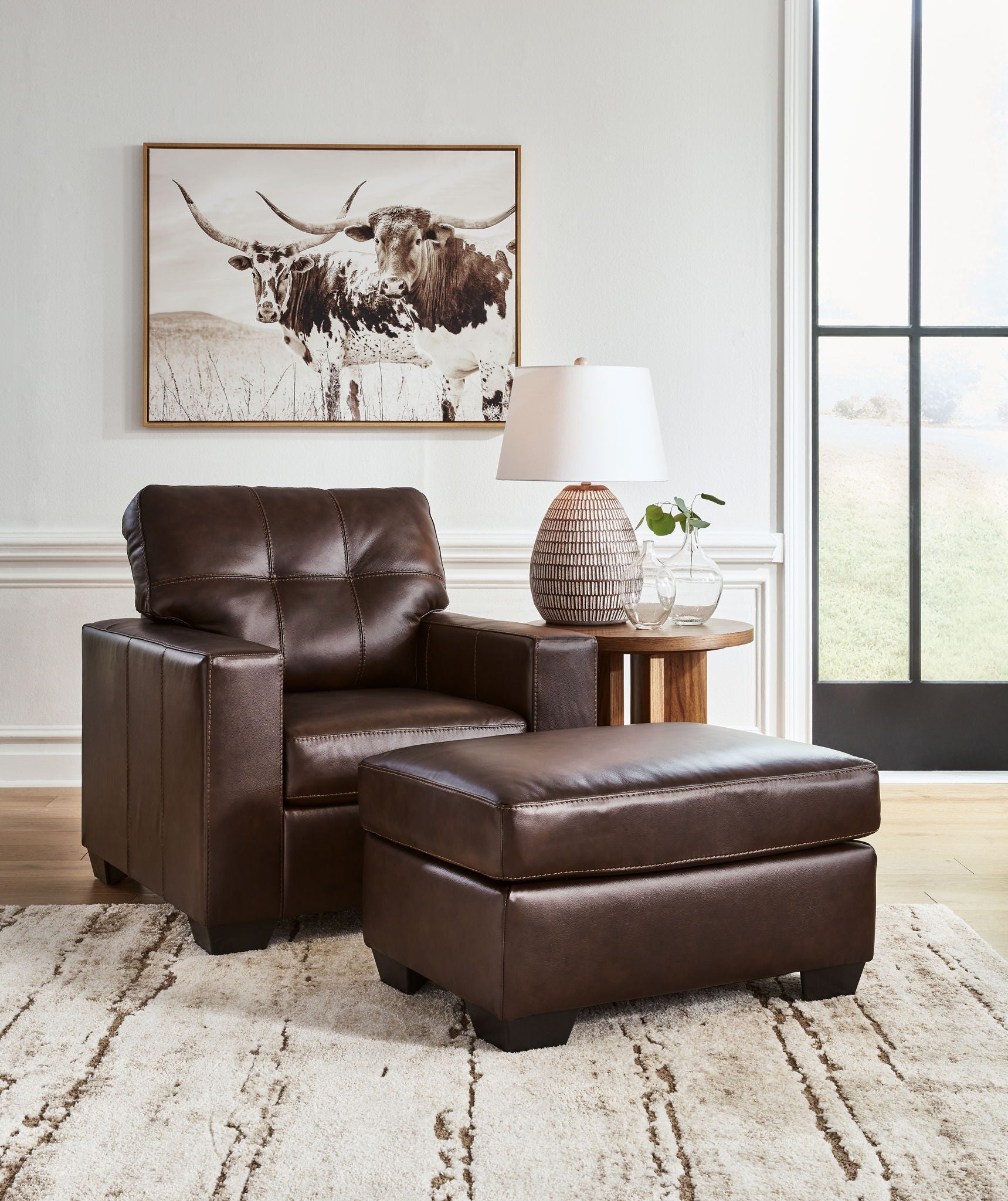 Dark brown upholstered lounge chair set with matching ottoman, front view
