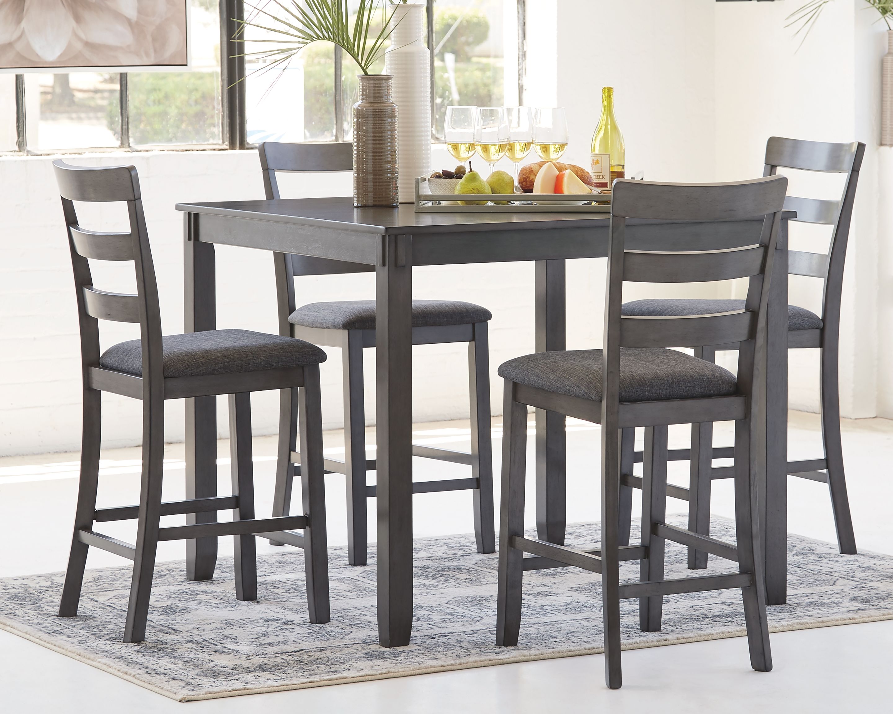 Gray square counter table with four matching stools, dark gray seats and backs.