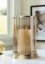 Aavinson glass candle holder with lit candle inside and gold base ring