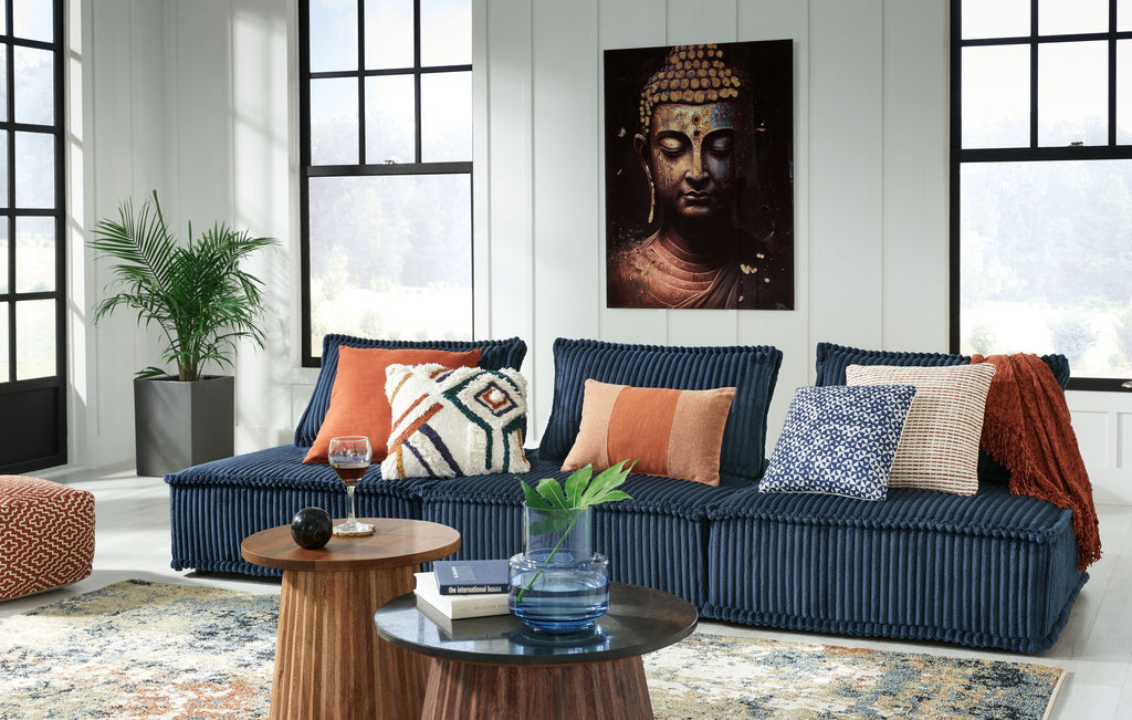 Navy modular sectional sofa with chaise and patterned accent pillows