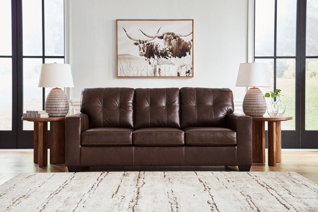 Dark brown leather sofa with three seat cushions and tufted back, block feet