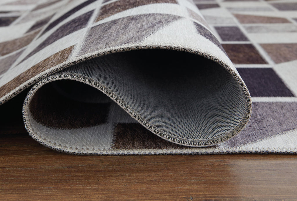 Jettner area rug edge close-up showing textured weave and layered backing