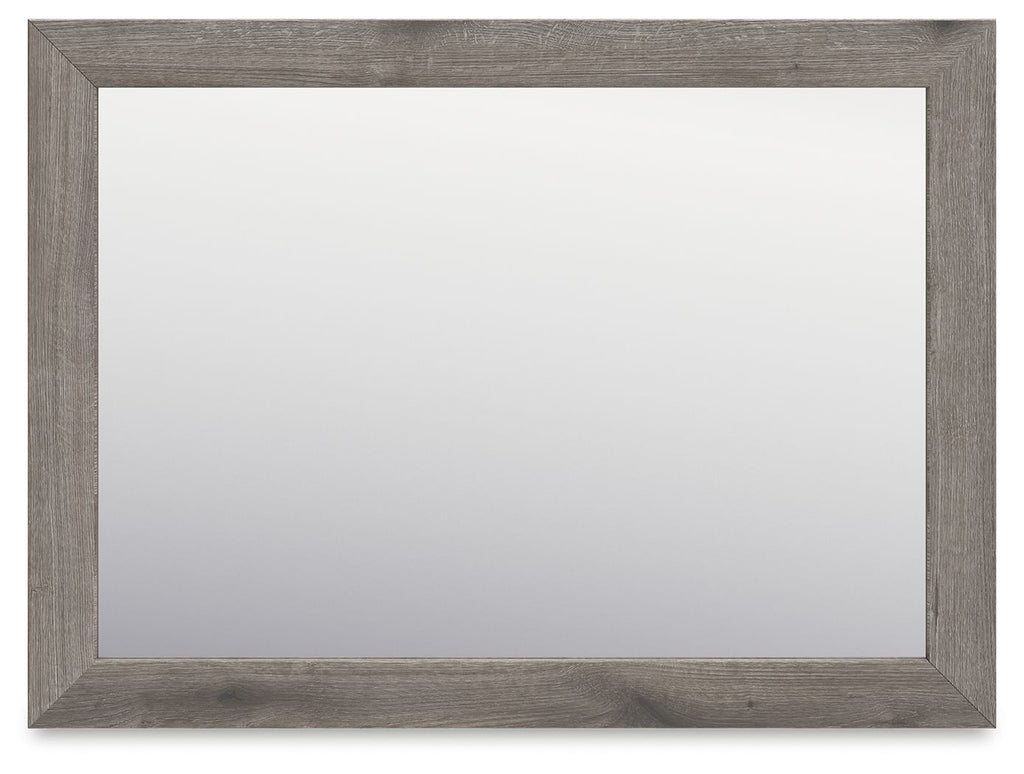 Rectangular bedroom mirror with gray-brown frame and clear reflective glass