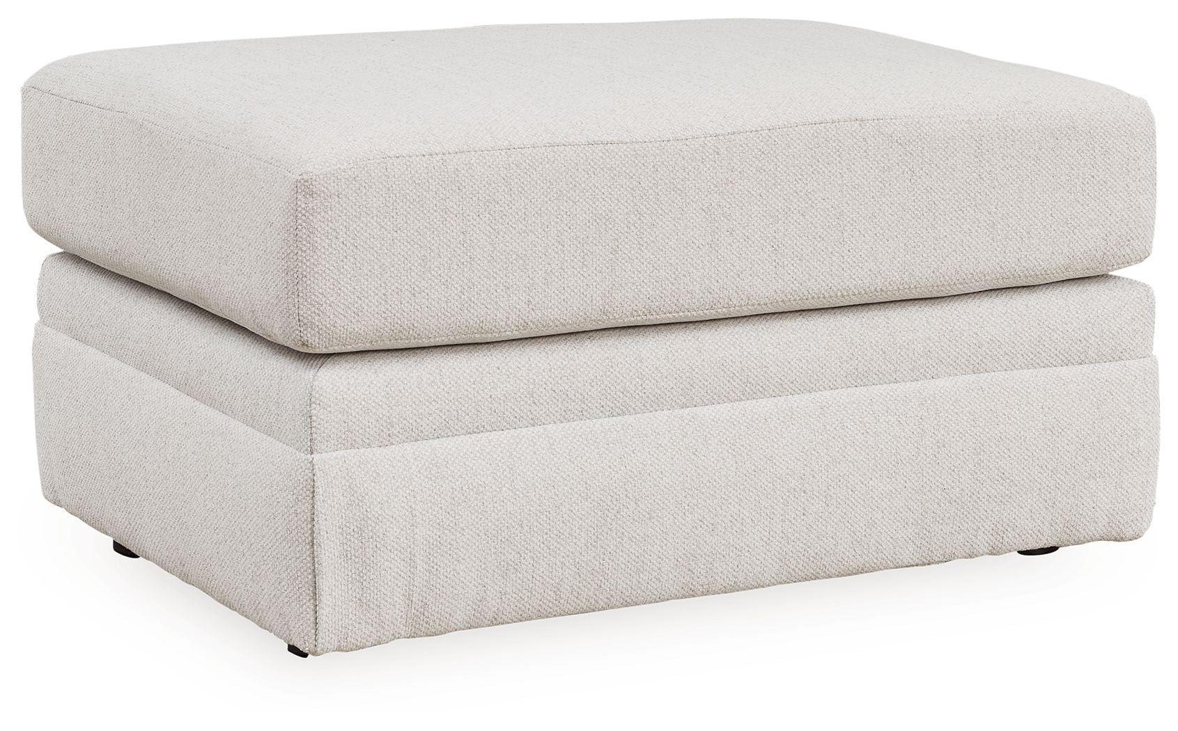Light beige fabric ottoman with cushioned top, smooth sides, short dark legs
