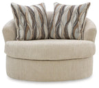 Beige swivel chair with deep rounded seat and patterned back pillows