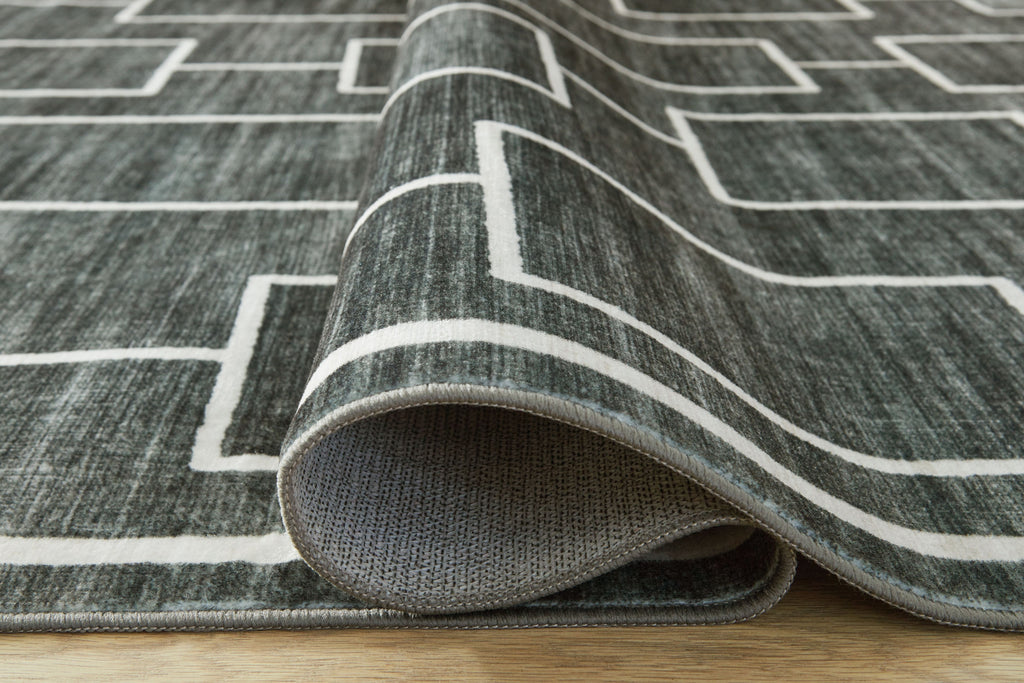 Elderland washable rug edge folded back, showing flat texture and white pattern lines