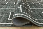 Elderland washable rug edge folded back, showing flat texture and white pattern lines