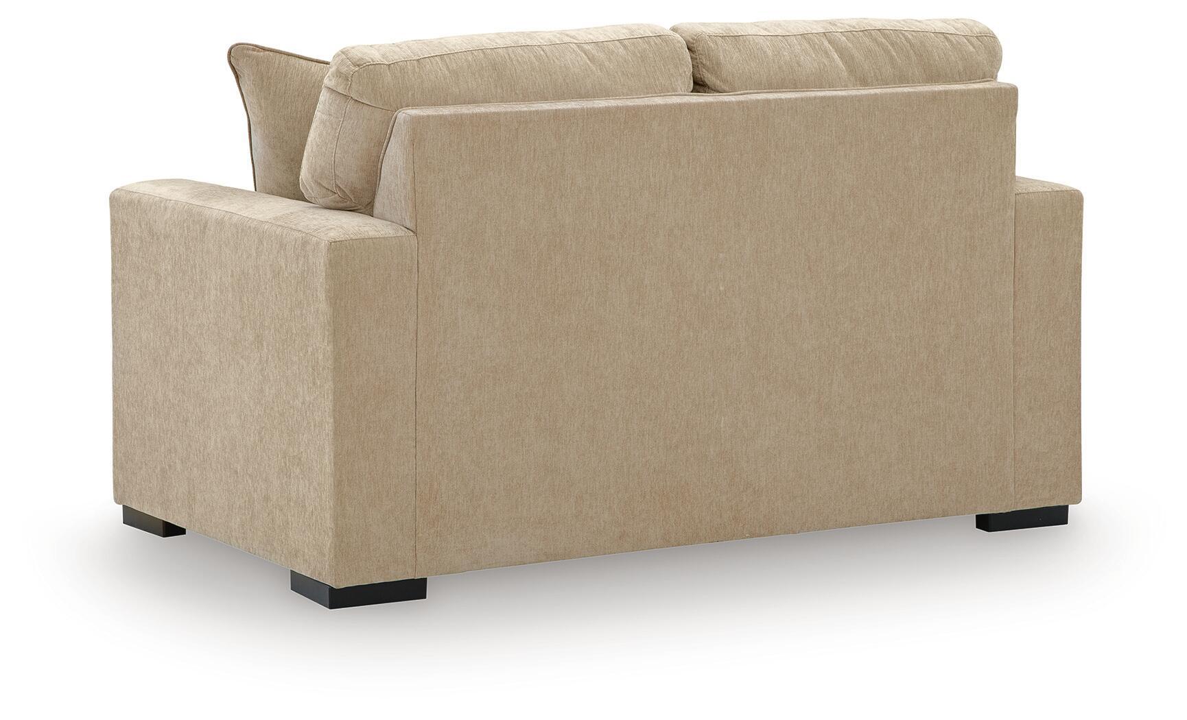 Light tan upholstered loveseat with two back cushions and wide arms