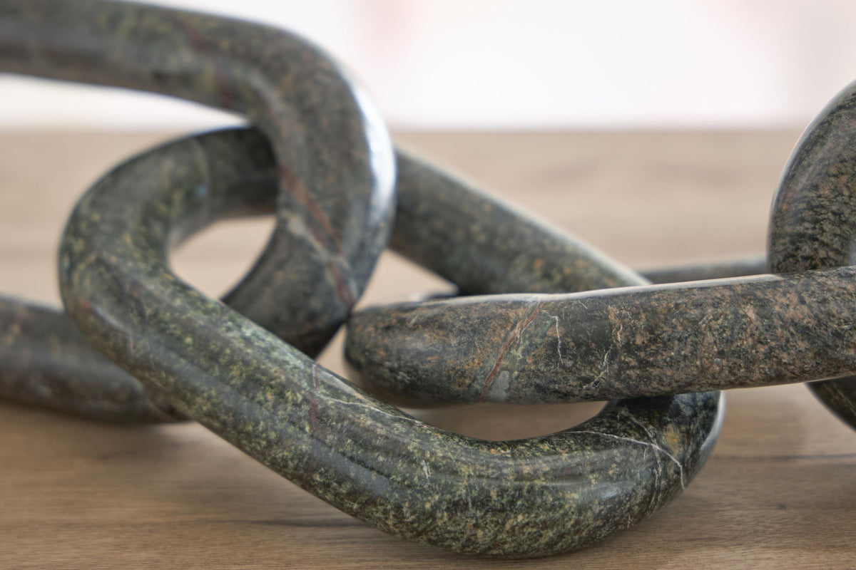 Close-up of green marble-look chain link sculpture with interwoven links