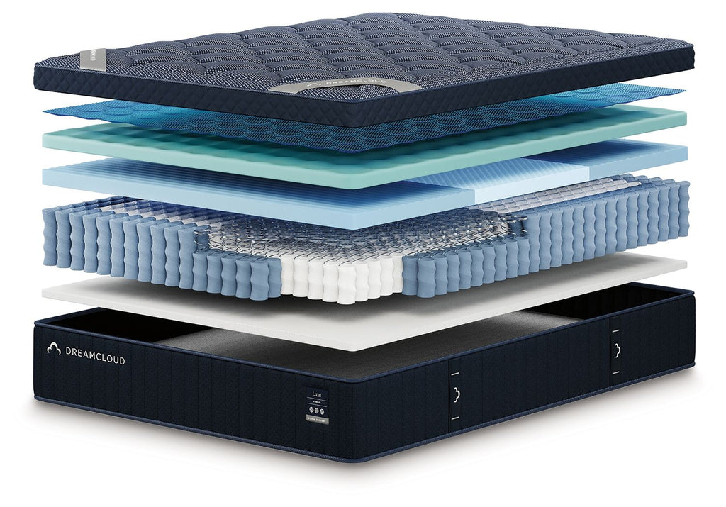 DreamCloud Luxe hybrid mattress with visible blue comfort layers and dark base