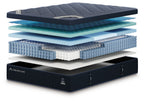 DreamCloud Luxe hybrid mattress with visible blue comfort layers and dark base