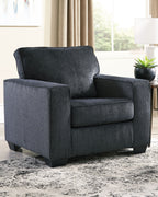 Dark gray fabric arm chair with rounded back, padded arms, and upholstered seat