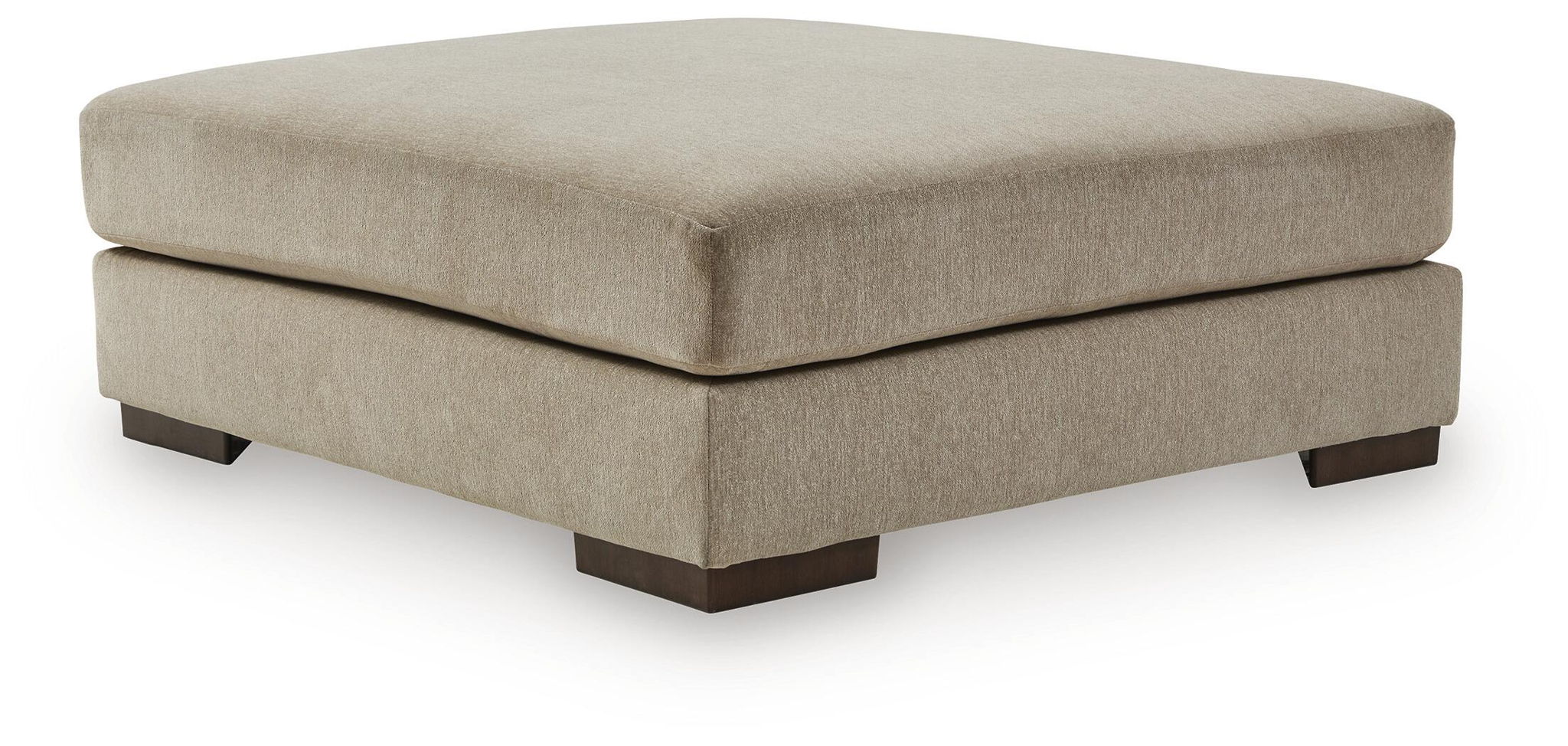 Oversized accent ottoman in dune beige fabric, rounded top and dark wood legs.