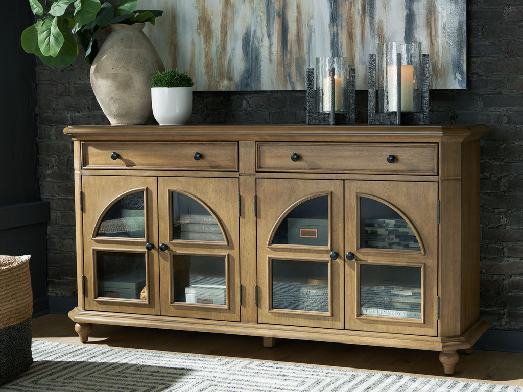 Brown accent cabinet with arched glass doors, two drawers, and tapered legs