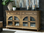 Brown accent cabinet with arched glass doors, two drawers, and tapered legs