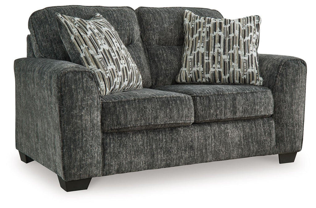 Gunmetal gray loveseat with textured fabric and three patterned accent pillows