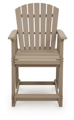 Light brown wooden barstool with slatted back, wide armrests, and front panel.