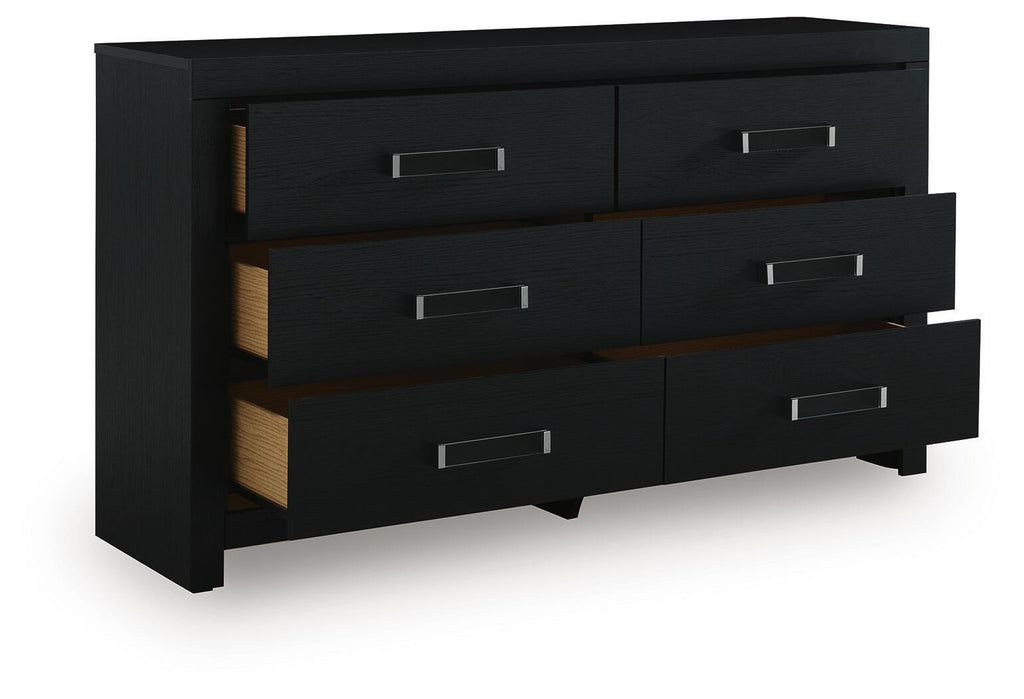 Black six-drawer dresser with angled view of drawers and silver bar handles.