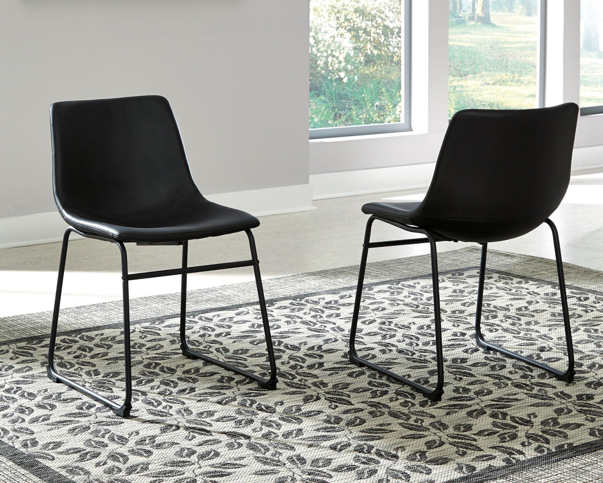 Black upholstered side chairs with curved backrest and sled legs, 2-pack
