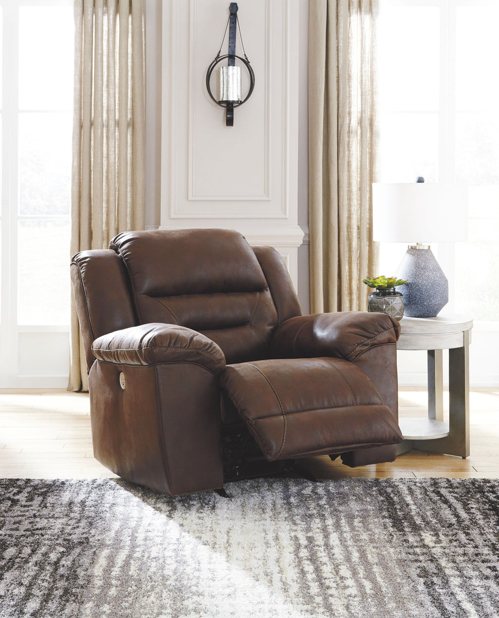 Dark brown power reclining armchair with padded arms and front footrest position